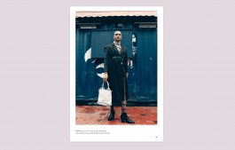 Man standing in healed boots, holding a bag, and staring at the camera, image from interview of Thomas Harvey with fashion historian Elizabeth Kutesko Elizabeth Kutesko