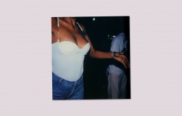 Woman dancing in jeans and white top at night Elizabeth Kutesko